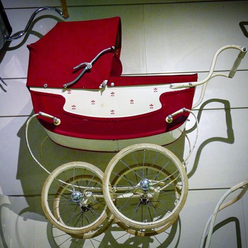 Red baby carriage on display at Glasgow Riverside Museum, Transport museum red pram
