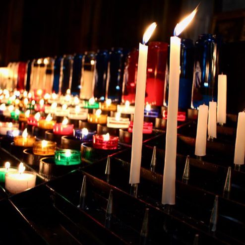 Glowing candles in St Eustache church, Paris France religious site