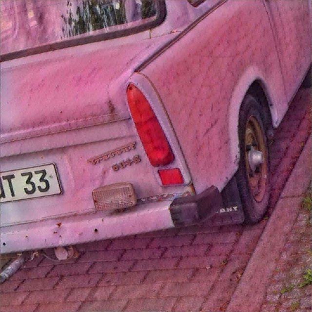 a pink trabant on the street, photos of berlin germany, photography in berlin, images of berlin