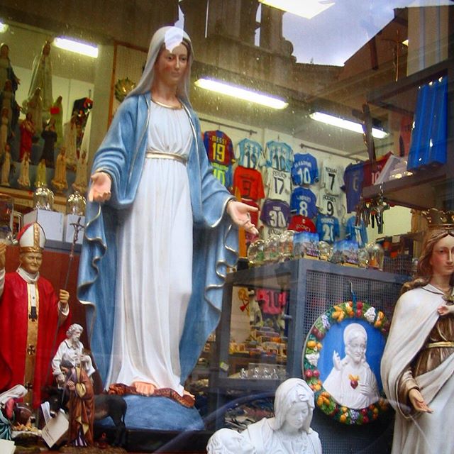 statues and soccer jerseys in rome, roman football strips, roma virgin mary, jesus mary and joseph, religious icons of italy, photography of store windows