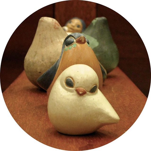 Ceramic birds from South America in a line